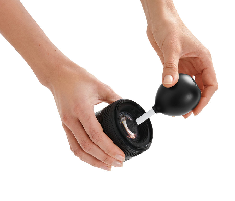 Kadın bir kamera lensini 2'si 1 Arada Üfleyen Fırça ile temizliyor.