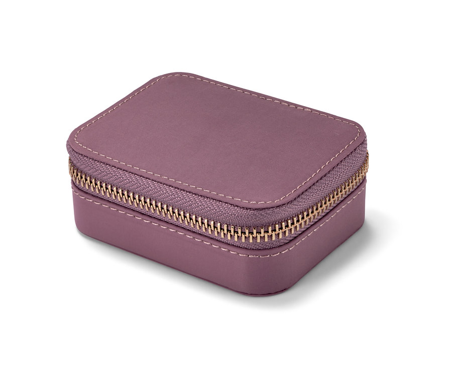 Altın fermuarlı mor ilaç kutusu yakından çekilmiş.