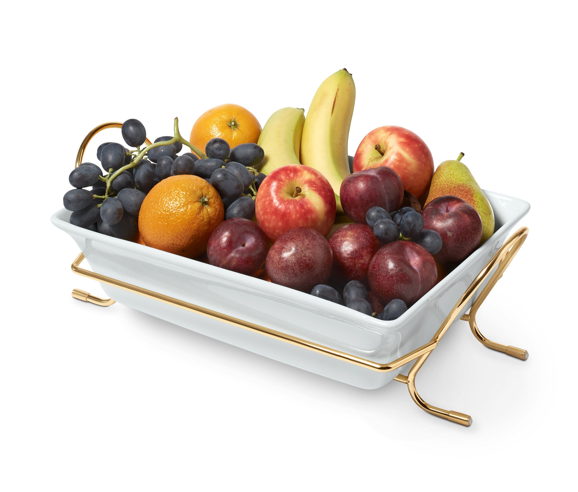 Metal standı olan porselen fırın kabında meyveler.