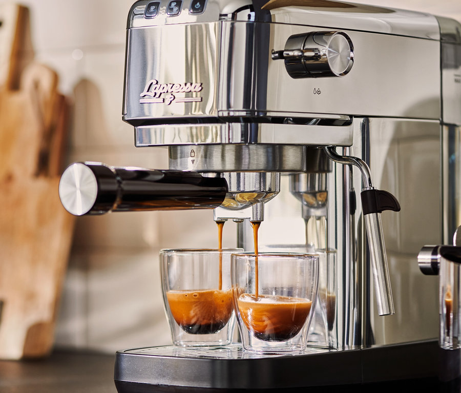 Gümüş renkli »Lapressa« Portafiltre Makinesi iki adet cam bardağa espresso hazırlıyor.