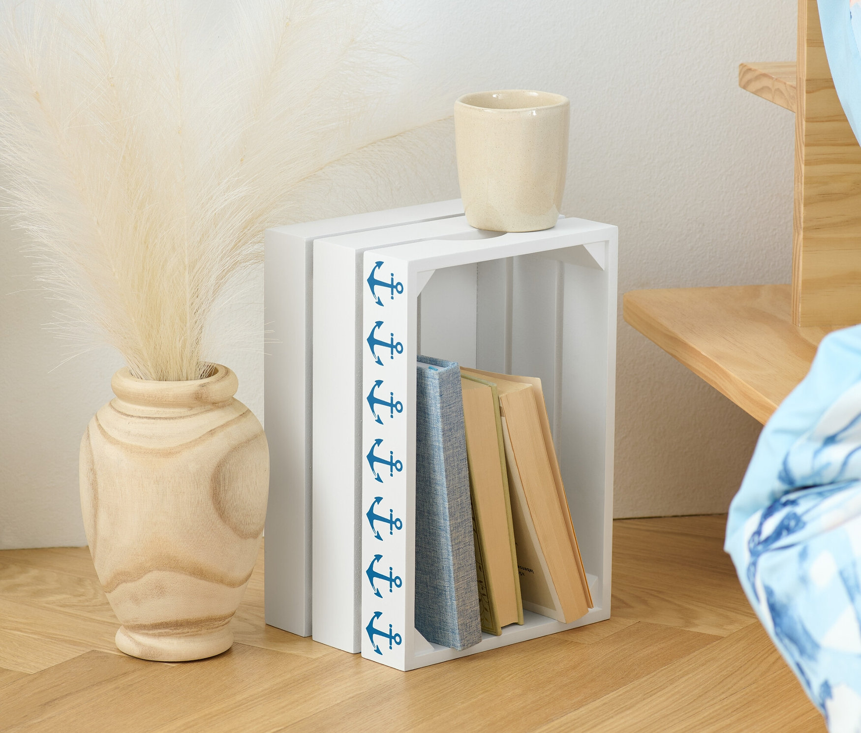 Dekoratif Ahşap Kasa, kitaplar, vazo ve pampa otu ile birlikte duruyor.