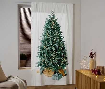 Pencerede Noel ağacı deseni olan beyaz bir perde asılı duruyor.