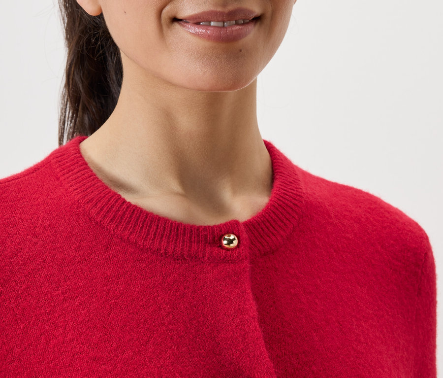 Kırmızı bir hırka giyen bir kadının yakın çekimi.