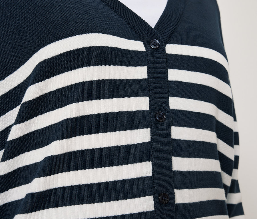 Beyaz çizgili ve düğmeli lacivert hırka detayı.