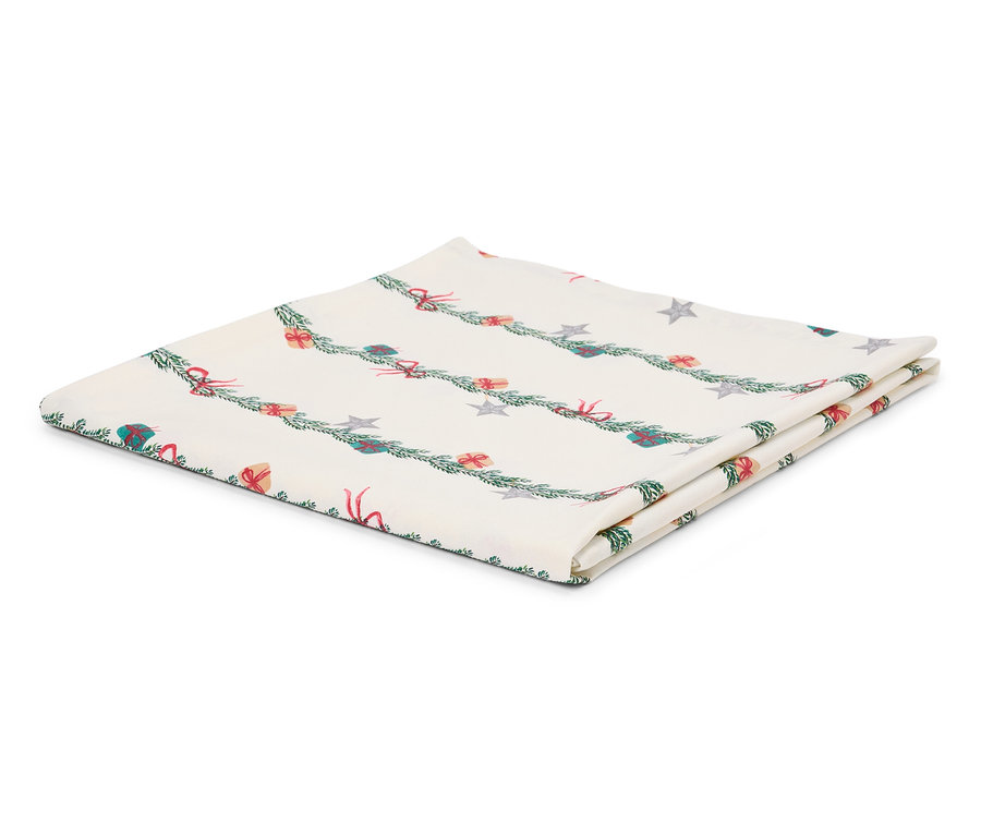 Katlanmış beyaz masa örtüsü üzerinde dallar, hediyeler ve yıldızlardan oluşan bir Noel motifi var.