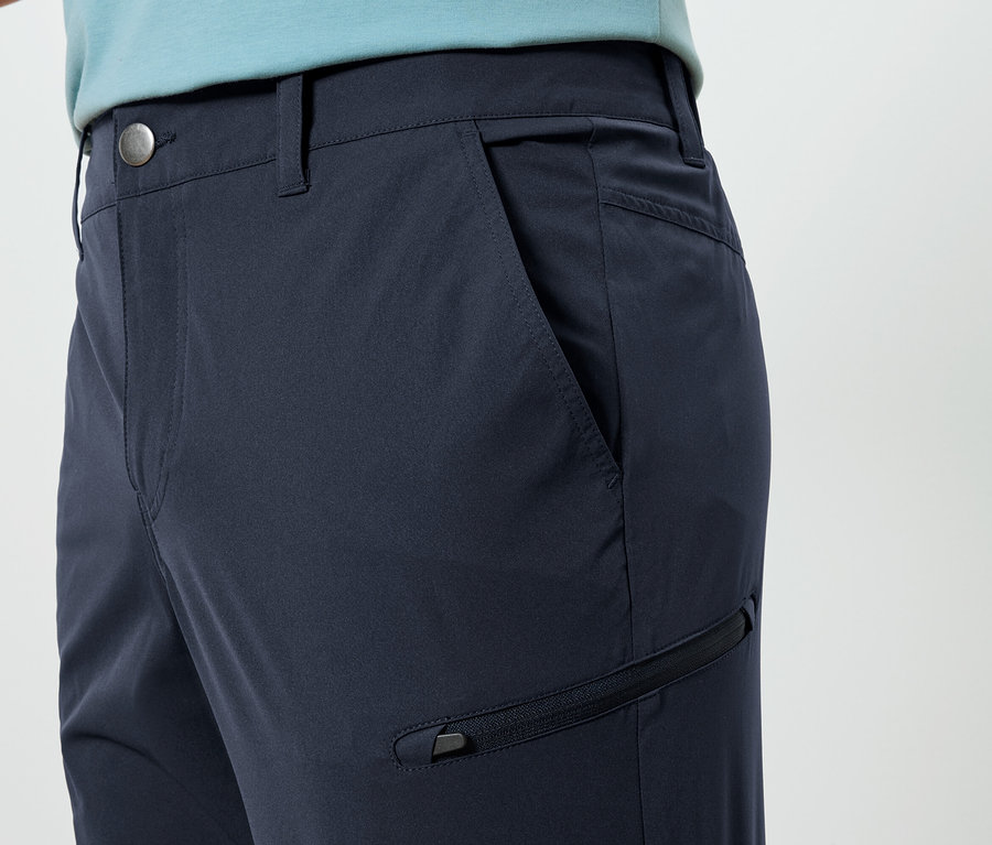 Cepli ve fermuarlı lacivert pantolonun yakın çekimi.