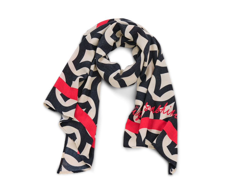 Krem, lacivert ve kırmızı renklerde baskılı dokuma şalın yakın çekimi.