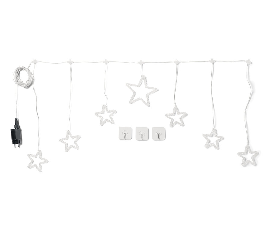 Beyaz arka planda yıldızları olan beyaz ışık zinciri ve üç kablo tutucu.