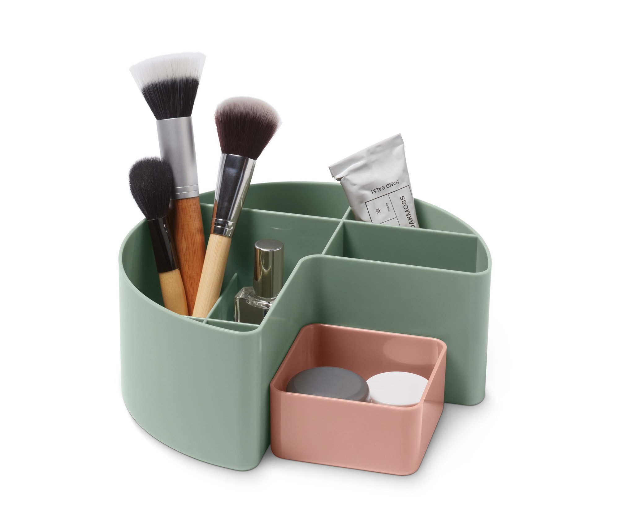 Makyaj fırçaları, parfüm ve el kremi yeşil bir makyaj malzemeleri düzenleyicide.