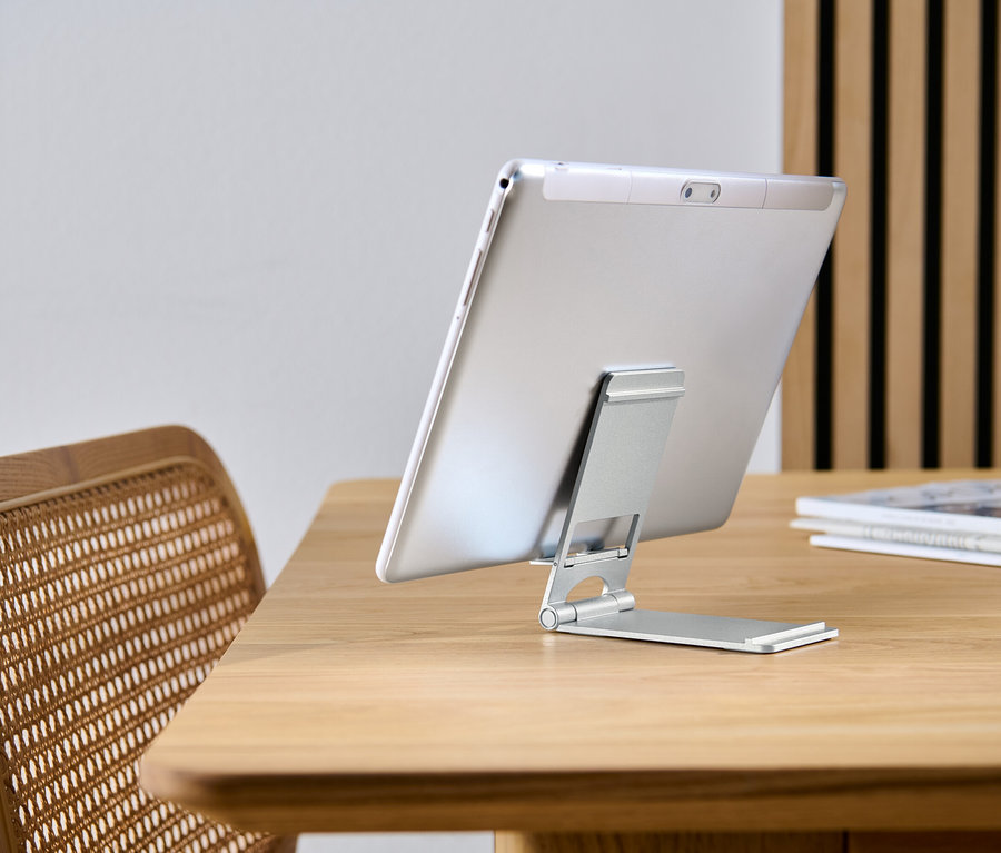 Tablet, ahşap bir masa üzerinde Akıllı Telefon ve Tablet Standına yaslanmış.