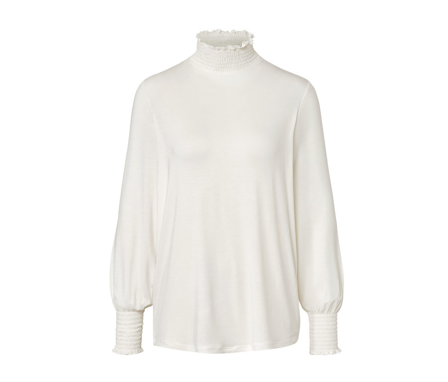 Krem rengi, dik yakalı bluz.