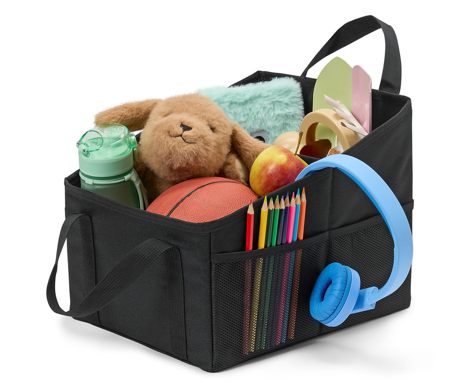 Oyuncaklar, boya kalemleri, kulaklıklar ve bir elma ile dolu siyah bir düzenleyici.