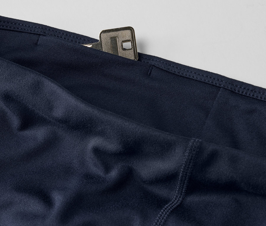 Cebinde anahtar bulunan lacivert renkli 3/4 spor taytın yakın çekimi.