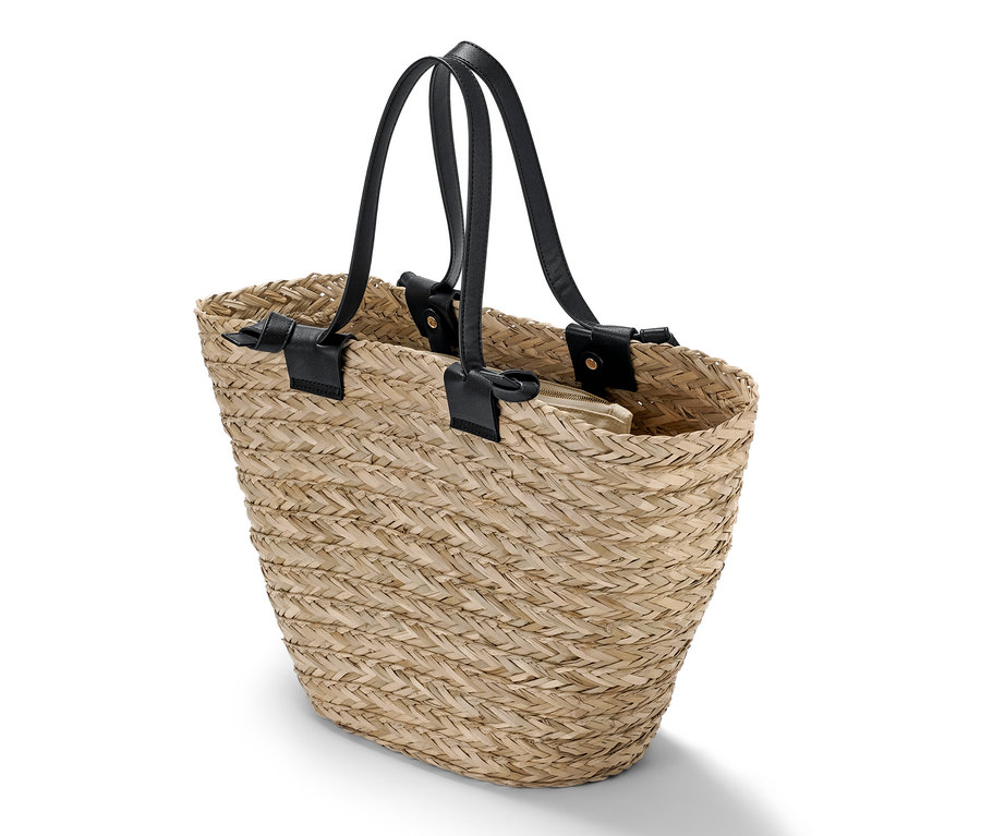 Siyah deri saplı ve bej renkli fermuarlı iç çantası olan bir sepet çantanın detayı.