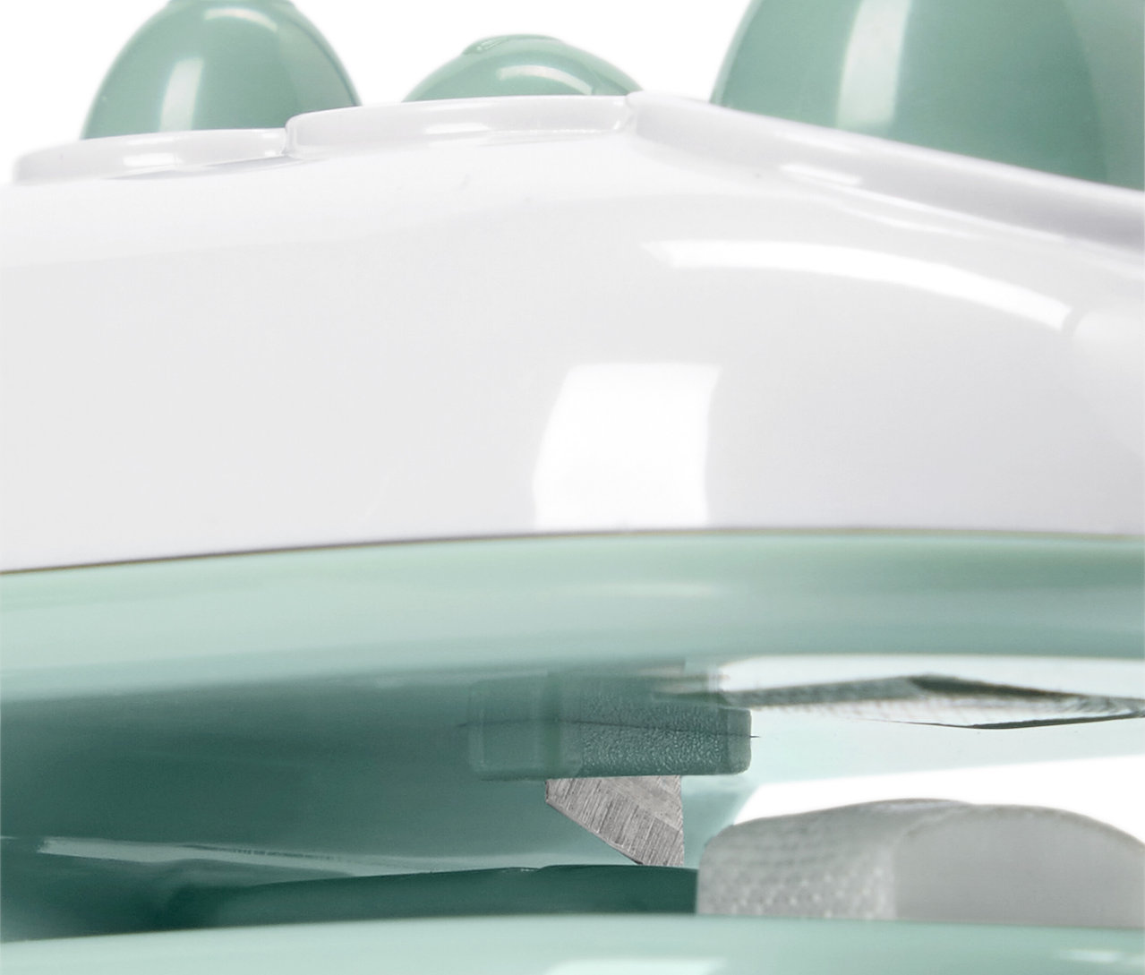 Beyaz ve açık yeşil renkli bir masaj aletinin yakın çekim görüntüsü.