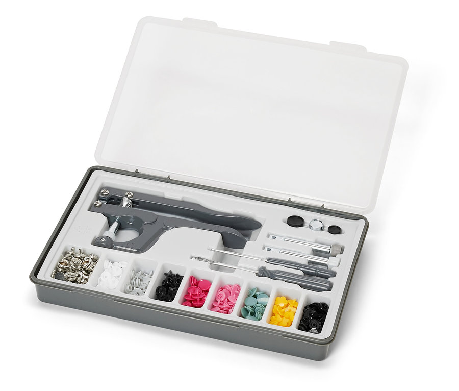 Şeffaf kapaklı açık gri kutu, içinde bir çıtçıt seti bulunuyor.