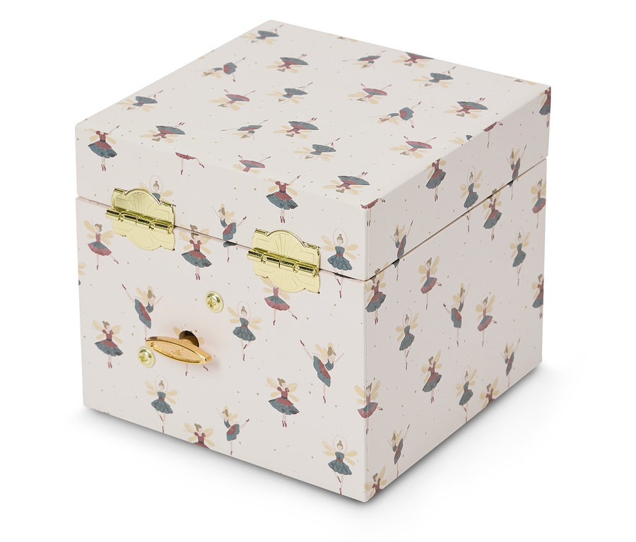 Açık renkli bir arka plan üzerinde balerin deseni olan bir müzik kutusunun yakından görünümü.