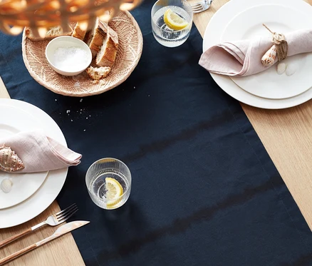 Batik Şeritli Runner, tabaklar, limonlu bardaklar ve keten peçetelerle donatılmış masa.