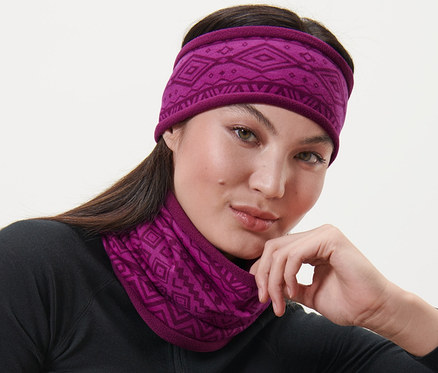Boynunda ve başında pembe termal polar boyunluk ve bandana olan kadın.
