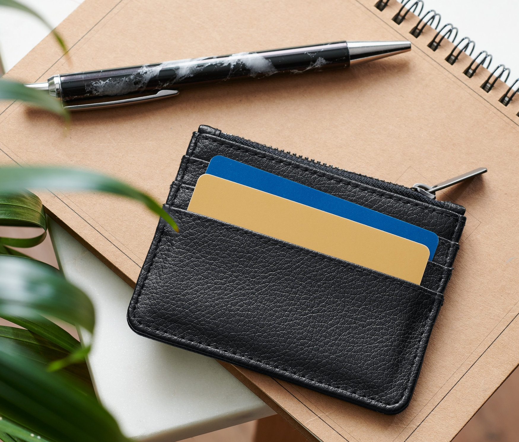 Siyah kartlık bir not defterinin üzerinde, yanında bir kalem var.