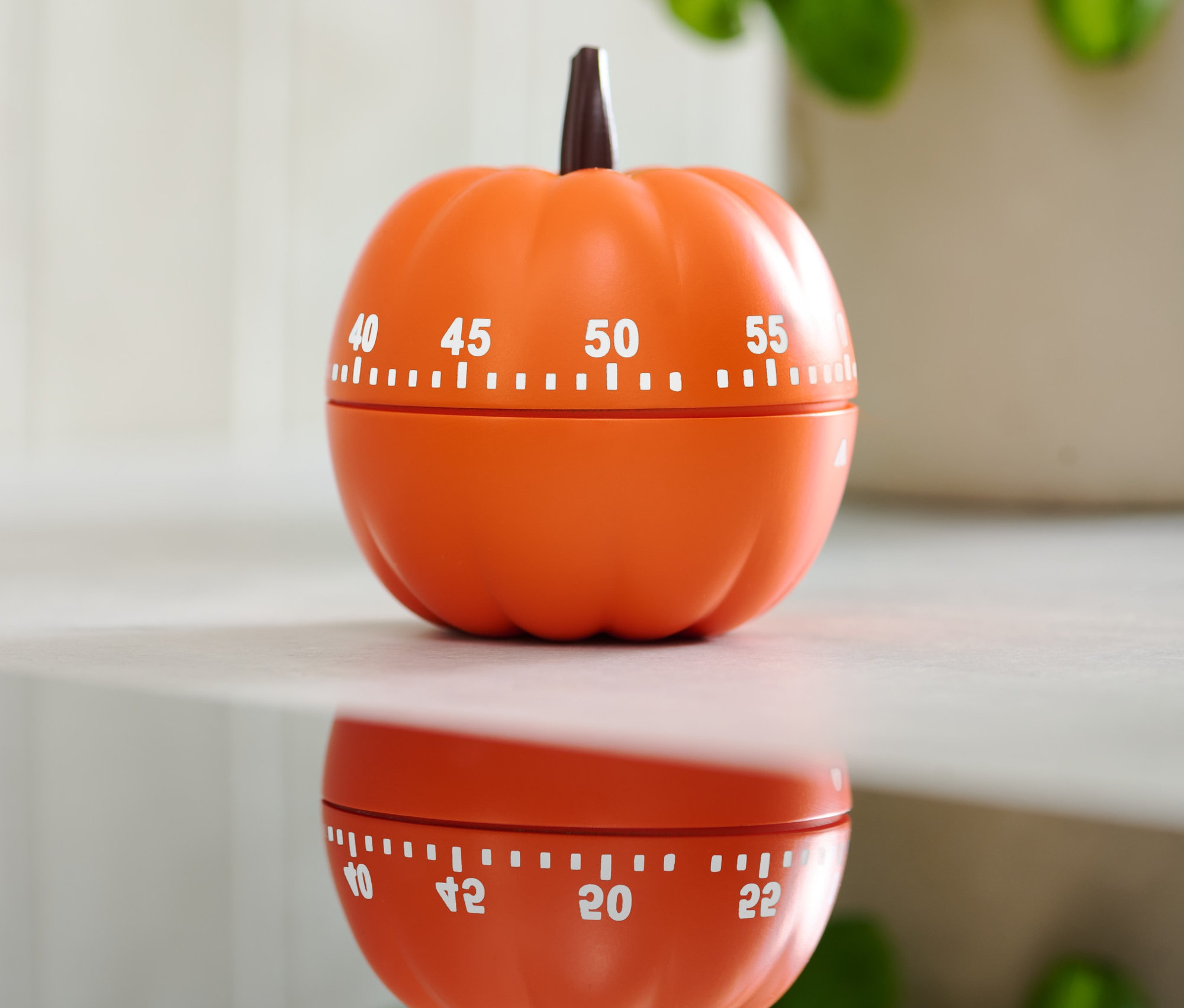 Parlak yüzey üzerinde balkabağı şeklinde turuncu mutfak zamanlayıcısı.