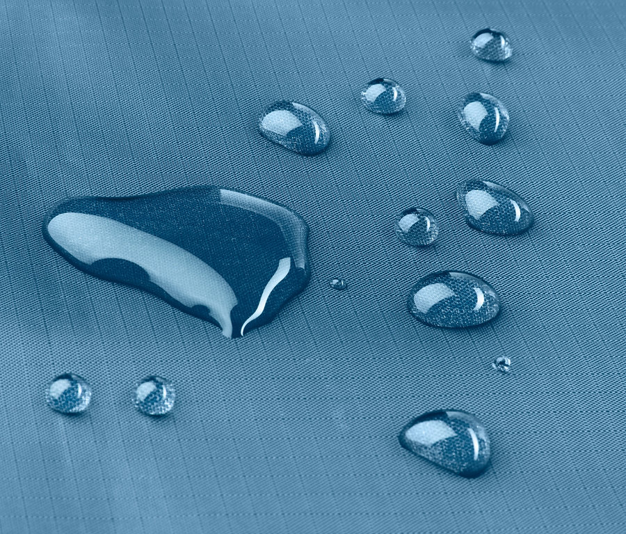 Mavi mini piknik örtüsünün üzerinde su damlaları var.