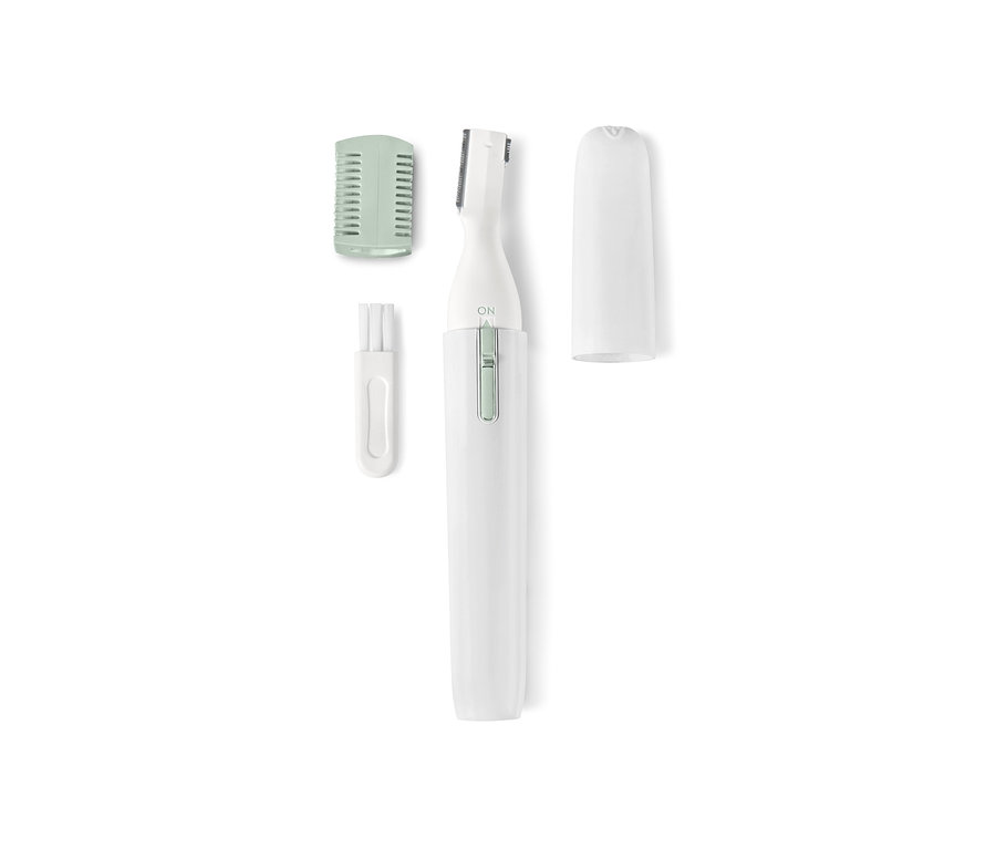 Başlıkları ve temizleme fırçasıyla birlikte elektrikli bir kozmetik tıraş makinesinin yakın çekimi.