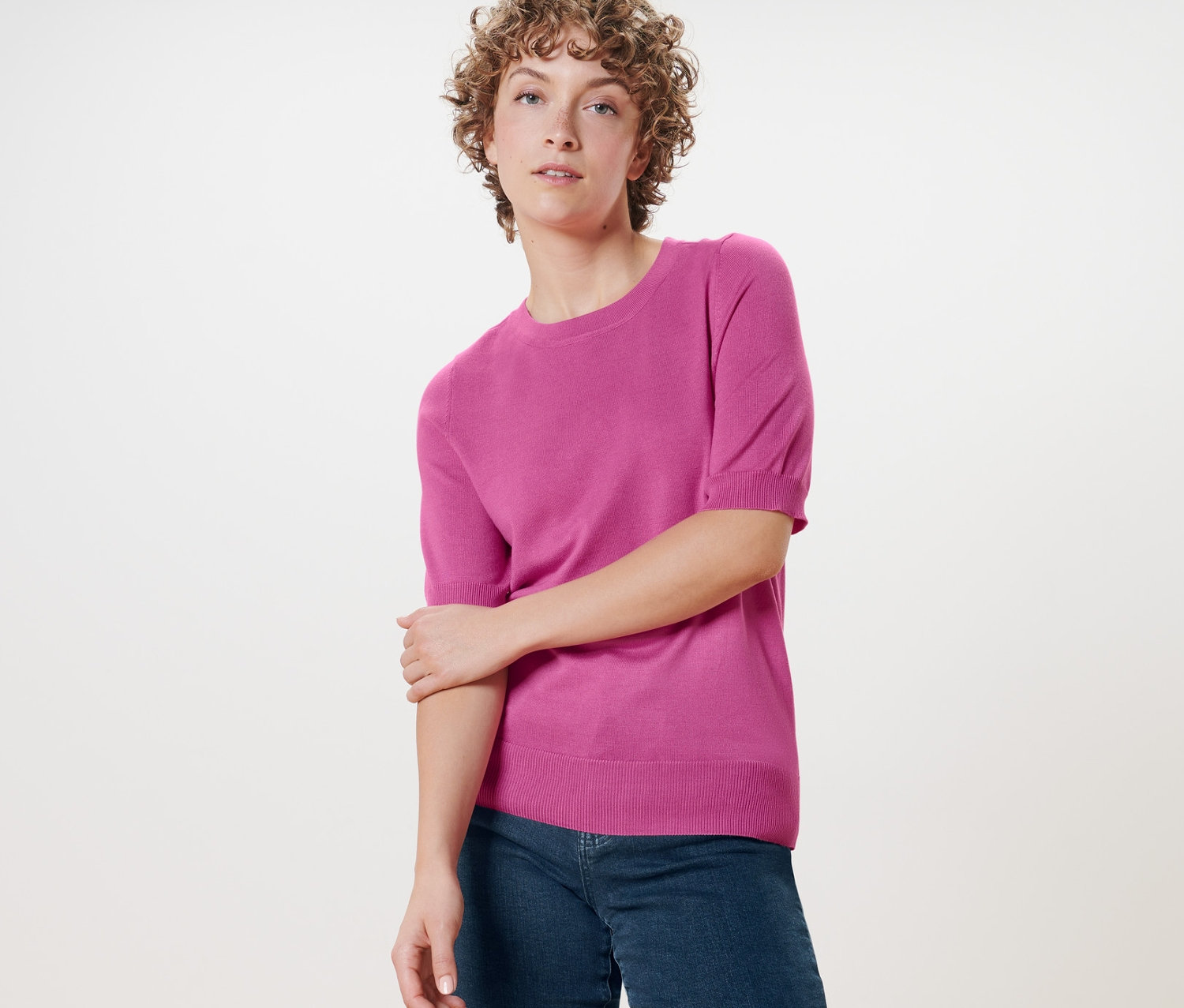 Kadın ince örgülü kazağıyla poz veriyor.