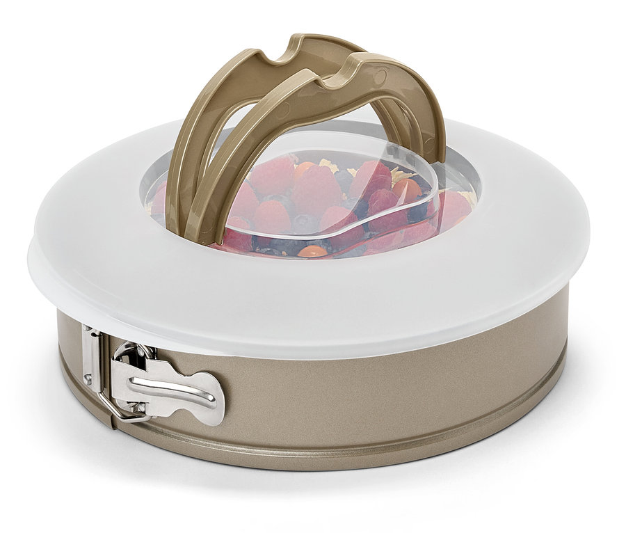 Meyve, kapak ve kulpları olan bir kek kalıbı.