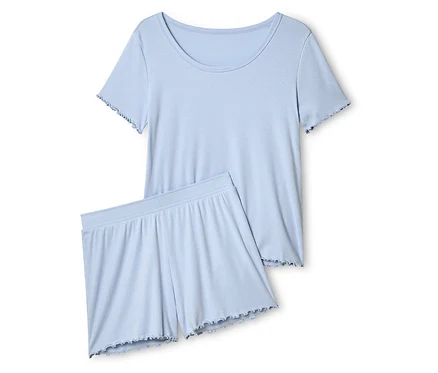 Açık mavi, kısa kollu üst ve fırfırlı şorttan oluşan pijama takımı.