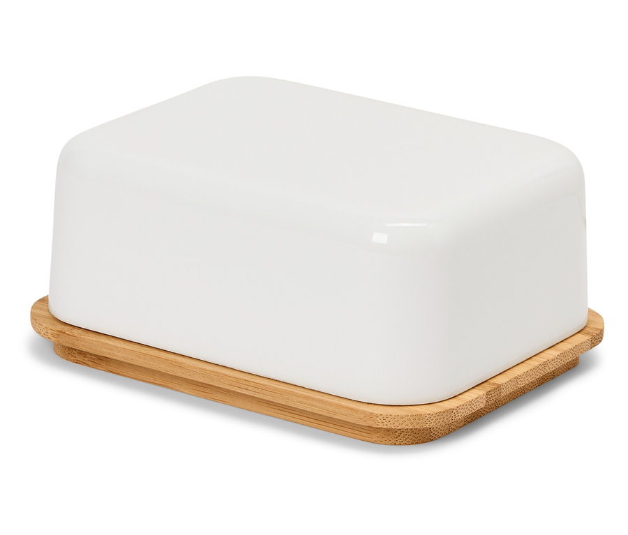 Beyaz bir yüzey üzerinde bambu kapaklı beyaz bir tereyağlık.