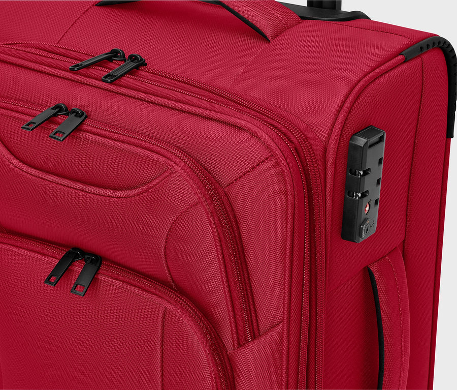 Siyah fermuarlı ve şifreli kilidi olan kırmızı kumaş bavulun yakın çekimi.