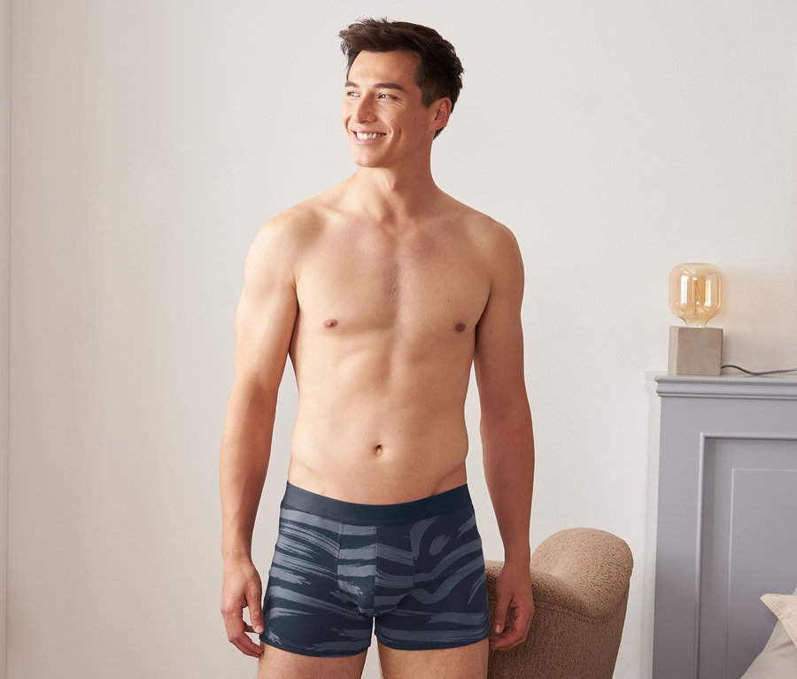 Adam, 2'li organik pamuklu slip boxerlardan birini giyiyor.