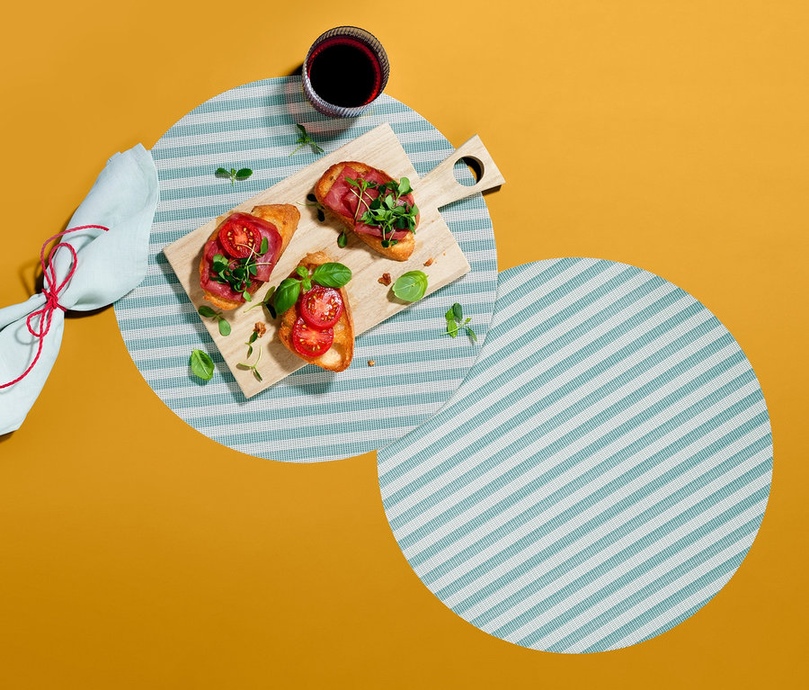 Çizgili Amerikan servislerinden ikisi, birinde içecek bardağı, bruschetta tahtası ve peçete var.