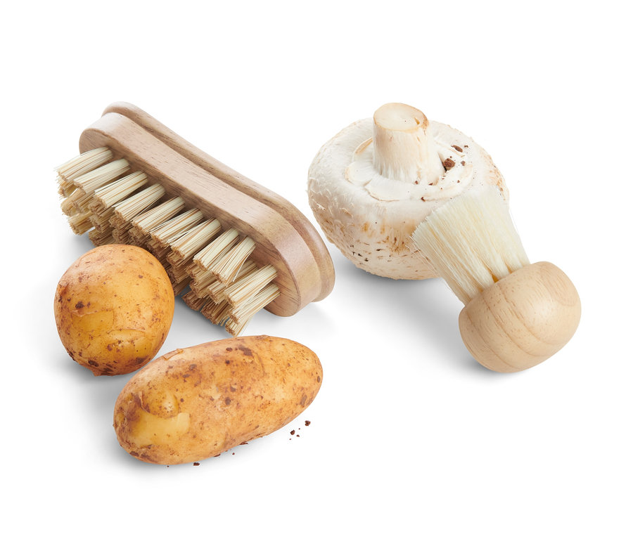 İki patates ve bir mantar, iki adet sebze fırçasının yanında.