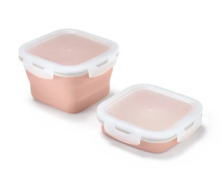 Beyaz kapaklı, açık pembe renkte iki adet katlanabilir saklama kabı.