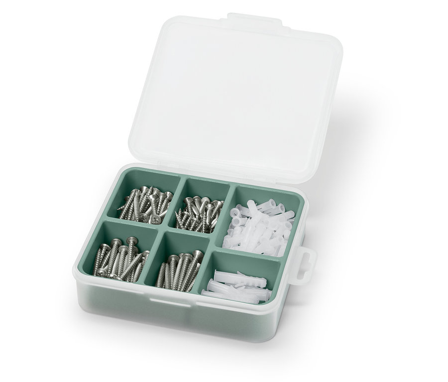 Beyaz ve yeşil bir kasada açık vida ve dübel seti.