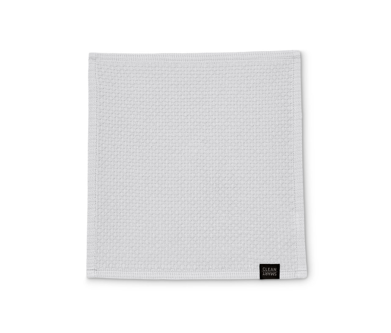 Beyaz bir yüzey üzerinde tek bir beyaz 3'lü bulaşık bezi düz duruyor.