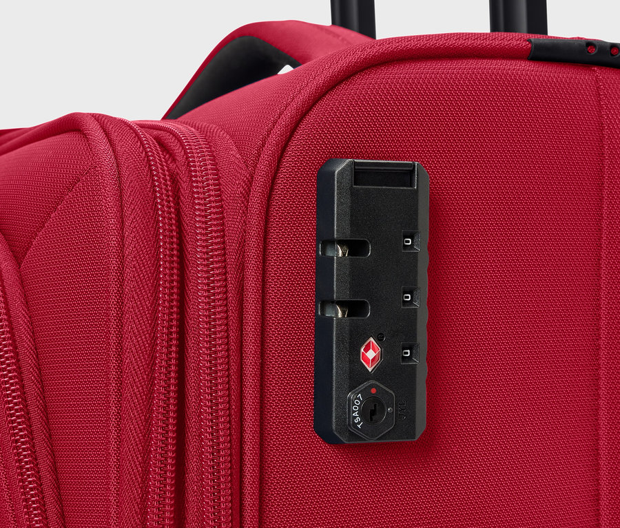 Kırmızı bir valizin şifreli kilidinin yakın çekimi.