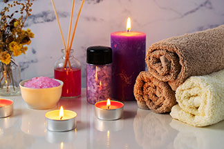 İyi hissetmek için mumlar: İki adet farklı yanan Tealight mum ve mor bir mumdan oluşan düzenleme, rahatlatıcı bir atmosfer sağlar.